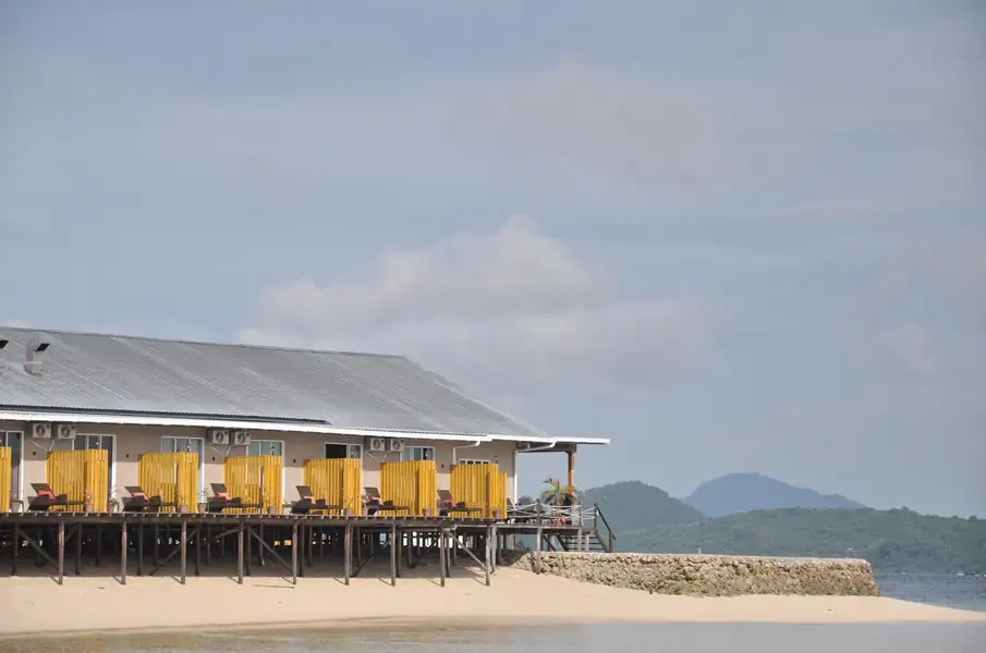 Scenic view of the wooden overwater chalets Santiri Island Resort