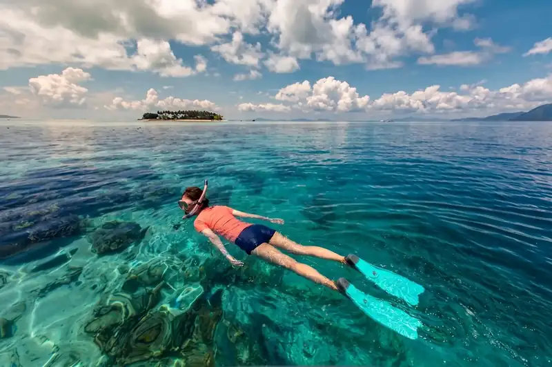 Snorkeling in the coral reefs of Tun Sakaran Marine Park Santiri Island Resort